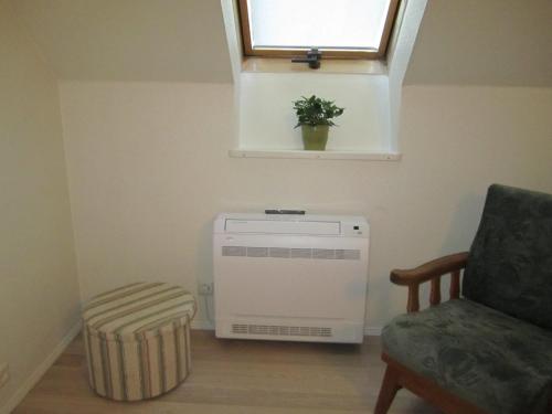 a room with a heater and a window and a chair at Tüve apartment in Kärdla