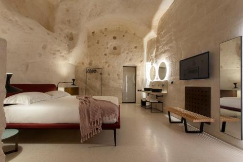 a bedroom with a large bed in a stone wall at PIANELLE RESORT in Matera