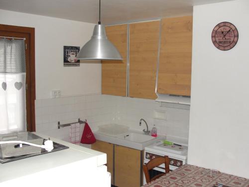 a kitchen with a sink and a counter top at appartement thones in Thônes