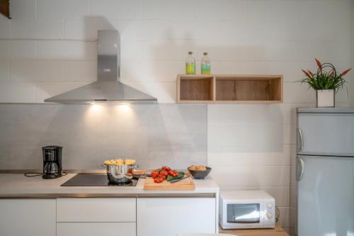 a kitchen with a counter top with a microwave at Residence Duna Rossa - Family Friendly in Duna Verde