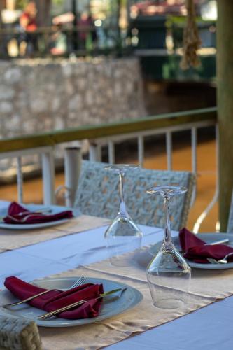 a table with two wine glasses and napkins on it at TURUNÇ DREAM HOTEL in Mugla