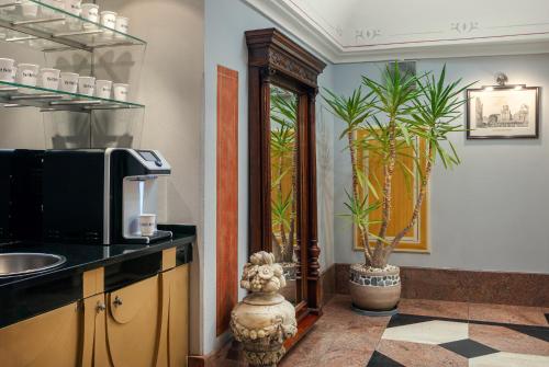 a kitchen with a counter with a microwave and a plant at The Charles in Prague
