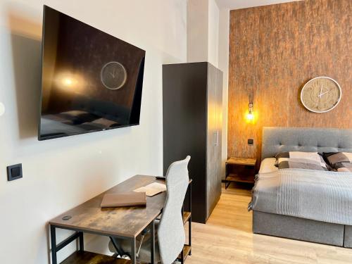 um quarto com uma cama, uma secretária e uma mesa em Apartment an der Altstadt # 1 em Hameln