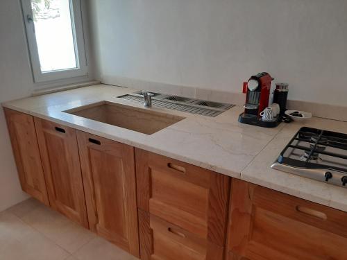 a kitchen counter with a sink and a window at Villa Dolce Bellezza in Salò