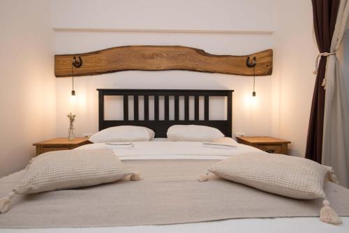a bedroom with a large bed with two pillows at SOBE NA FARMI 