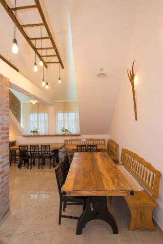 a large room with wooden tables and chairs at SOBE NA FARMI in Donji Sređani