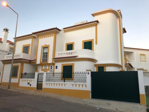 a large white house with a fence in front of it at Villa Do Mar SW in Zambujeira do Mar