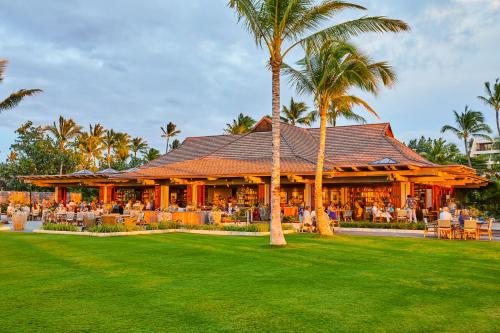 un complejo con un restaurante con gente sentada en las mesas en Mauna Lani, Auberge Resorts Collection, en Waikoloa