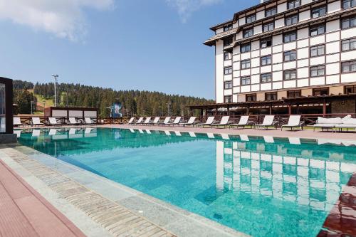 a large swimming pool in front of a building at Hotel Grand Kopaonik in Kopaonik