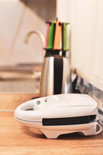 a white appliance sitting on top of a table at DelMar Apartments in Golem