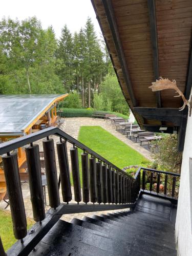 a wooden staircase leading to a building with a roof at Haus Petra in Stadtkyll