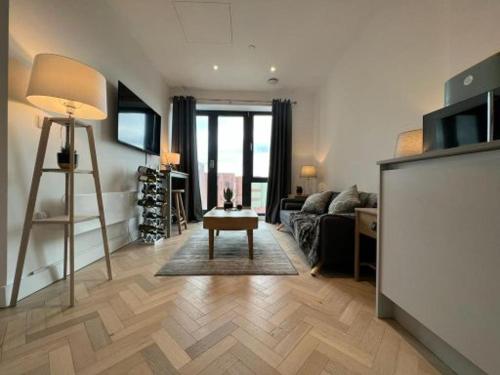 a living room with a couch and a table at STYLISH 1 BED & PARKING-IDEAL FOR CORPORATE STAYS - By Tempstay in Slough
