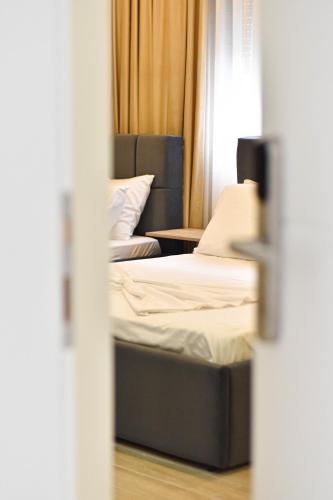 a room with two beds and a table at HotelApart - DelMar in Durrës