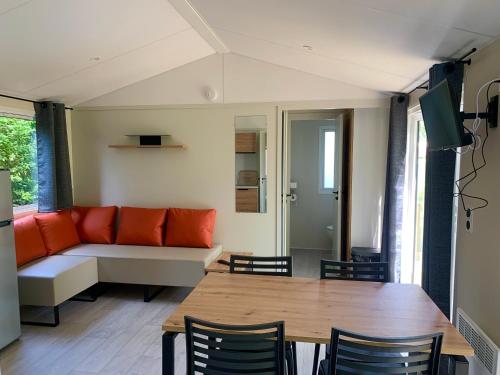 a living room with a couch and a table at L'auberge du moulin des prés in Maroilles