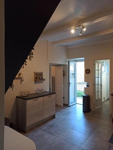 a large kitchen with a counter and a door at Chez Laurette Murato in Murato