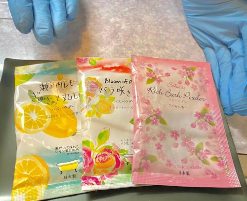 three packages of peach edible packets sitting on a table at Tabist Hotel Aurora Ikebukuro in Tokyo