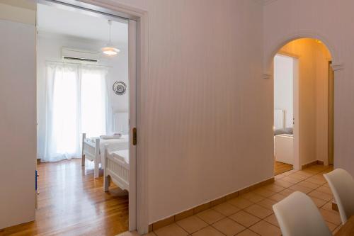 a living room with a room with a table and chairs at Euphoria apartment in Corfu Town