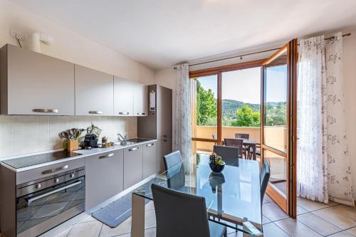 a kitchen and dining room with a glass table at Kastel's house in Roe