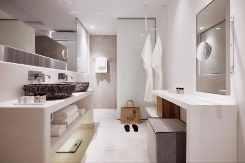 a bathroom with a sink and a mirror at Kantouni Beach Boutique Hotel in Panormos Kalymnos