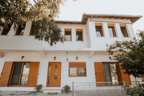 a house with wooden doors and windows at Panoramic Vlachos in Gjirokastër