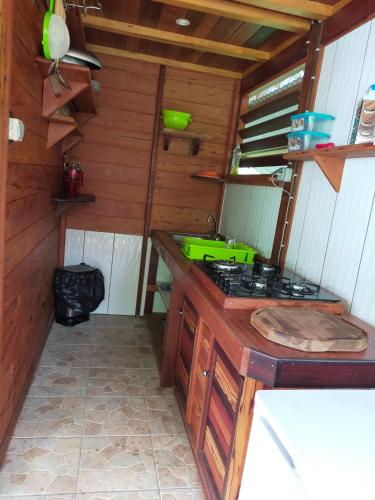 a kitchen with a sink and a stove at Carbet Bawouette in Saül