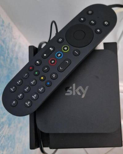 a remote control sitting on top of a video game controller at Appartamento sofí in Fiumicino