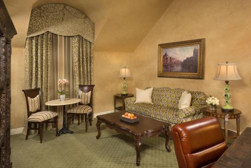a living room with a couch and a table at Ayres Hotel Manhattan Beach in Hawthorne
