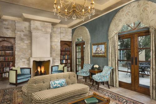 a living room with a couch and a fireplace at Ayres Hotel Manhattan Beach in Hawthorne
