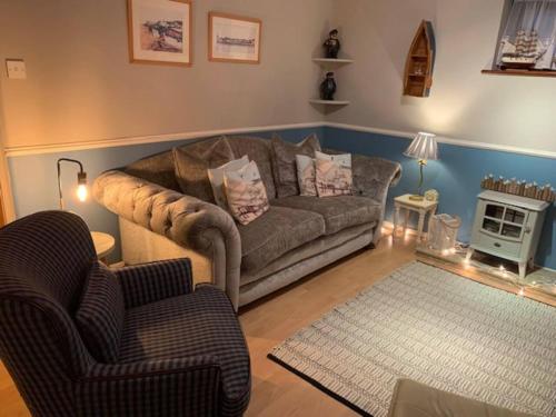 a living room with a couch and two chairs at Coastal Chalet Retreat in St Margaret's Bay in St Margarets at Cliff
