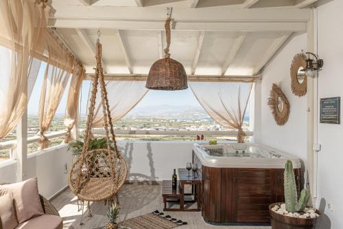 a room with a hammock and a large window at Black Velvet in Agkidia