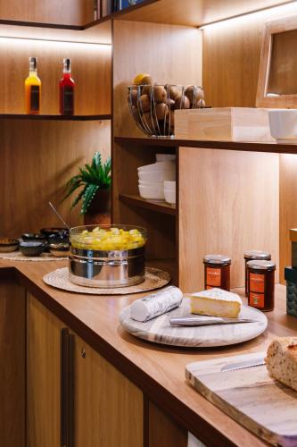 a kitchen with a counter with food on it at Hotel Des Remparts Perrache in Lyon