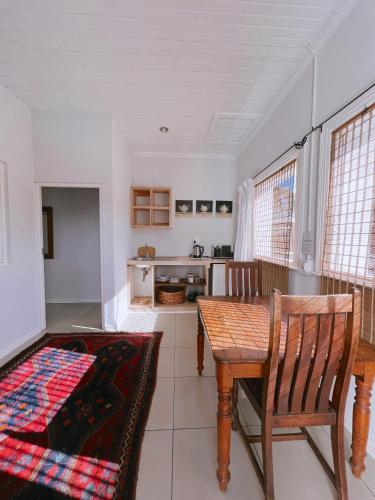 a kitchen with a table and chairs in a room at Ebony Lodge in Mthatha