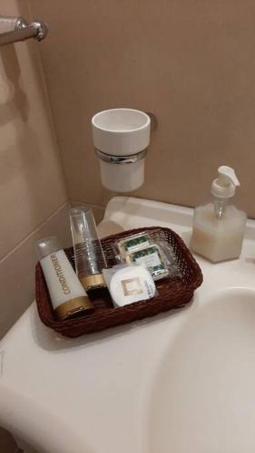 a tray of cosmetics sitting on top of a toilet at Apart Boutique Flor de Lis - con cochera- in Santa Fe