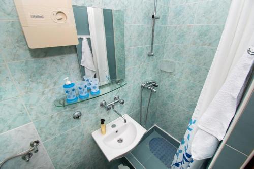 a bathroom with a sink and a mirror at Apartments Danica in Murter