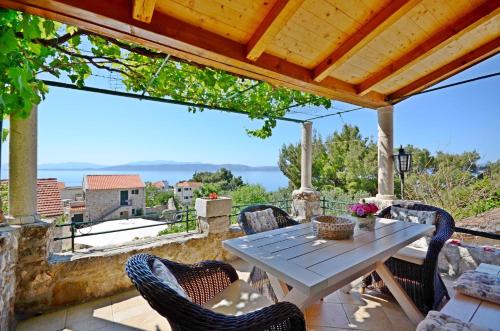 una mesa y sillas en un patio con vistas en House Vedrana en Igrane