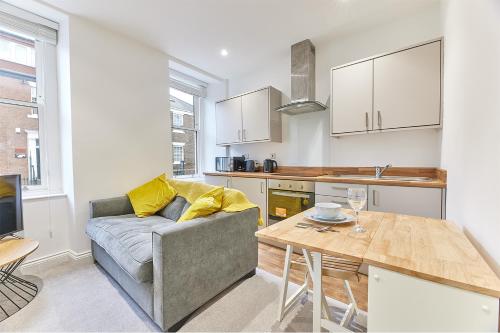 a living room with a couch and a table at Penshaw Boutique Apartment in Sunderland