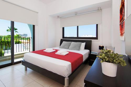 a bedroom with a large bed and a large window at Villa Greko in Protaras