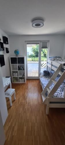 a room with two bunk beds and a window at Rozmarin Bled in Bled