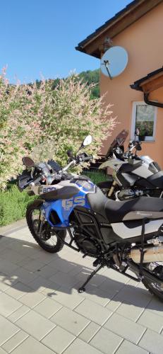 a motorcycle parked in front of a house at Apartman Urban Nature in Otočac