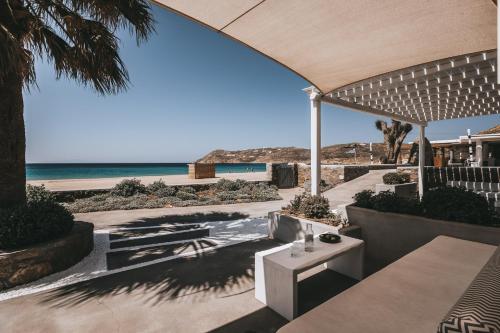 a patio with a view of the beach at Elia Mykonos Resort in Elia Beach