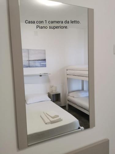 a mirror reflection of a room with two beds at Fascino del Cilento in Caprioli