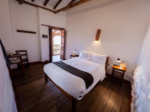 a bedroom with a large white bed in a room at El Balcón in Cusco