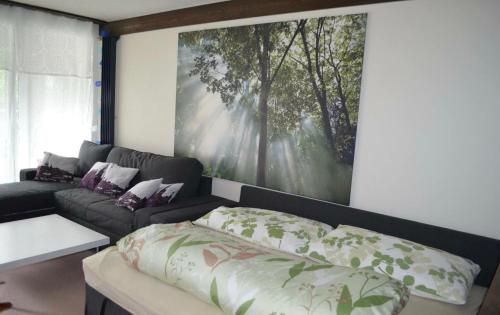 a living room with a bed and a couch at Ferienwohnung Engelberg in Engelberg