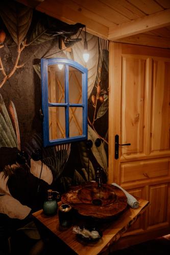 a bathroom with a sink and a mirror on a wall at Jurty z widokiem, prywatna balia- DZIKOLAS GLAMPING in Krasnobród
