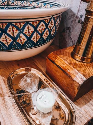 a tray with a candle and a bowl on a table at Jurty z widokiem, prywatna balia- DZIKOLAS GLAMPING in Krasnobród