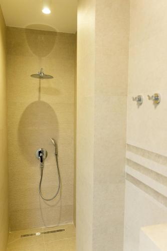 a shower with a shower head in a bathroom at Villa Forte Mare in Petrovac na Moru
