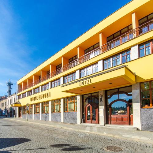 a yellow building on a street at Hotel Kotyza in Humpolec