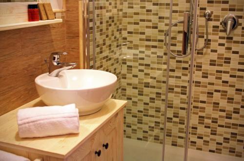 a bathroom with a sink and a shower at Fiumicino Airport B&B Deluxe in Fiumicino