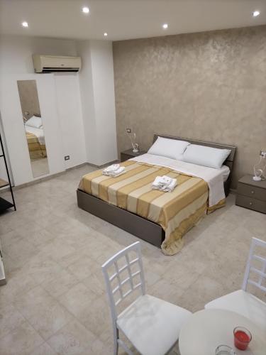 a bedroom with a bed and a table and chairs at Beb lungo tiflis matrimoniale, quadrupla in Bitonto