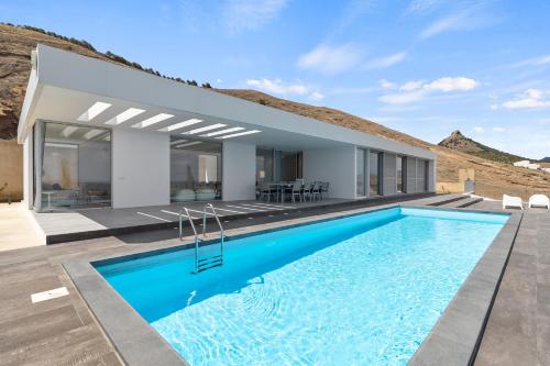 a villa with a swimming pool and a house at Casa do Azimute by Real Vision in Porto Santo